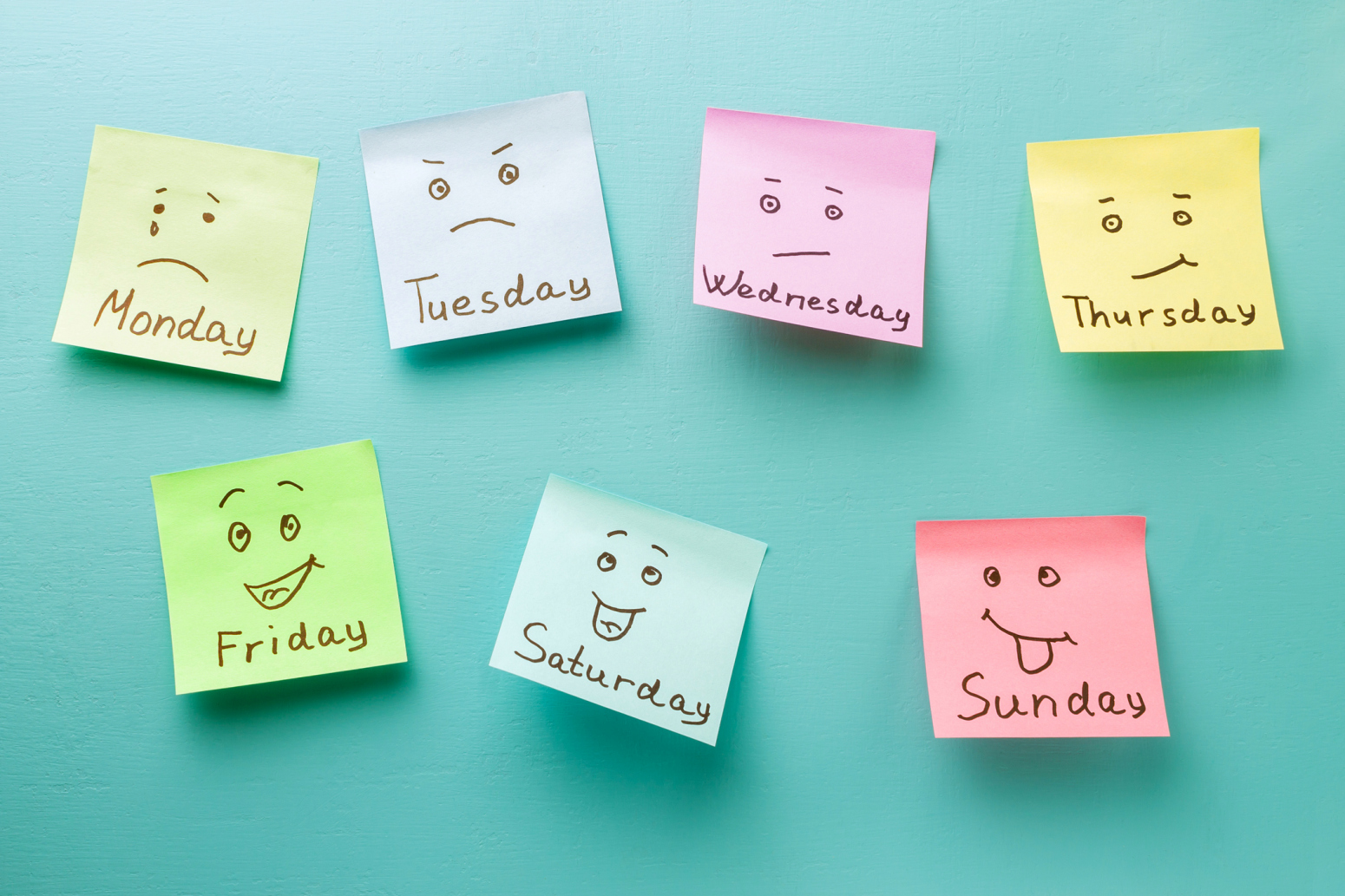 Colorful sticky notes with faces for each day of the week