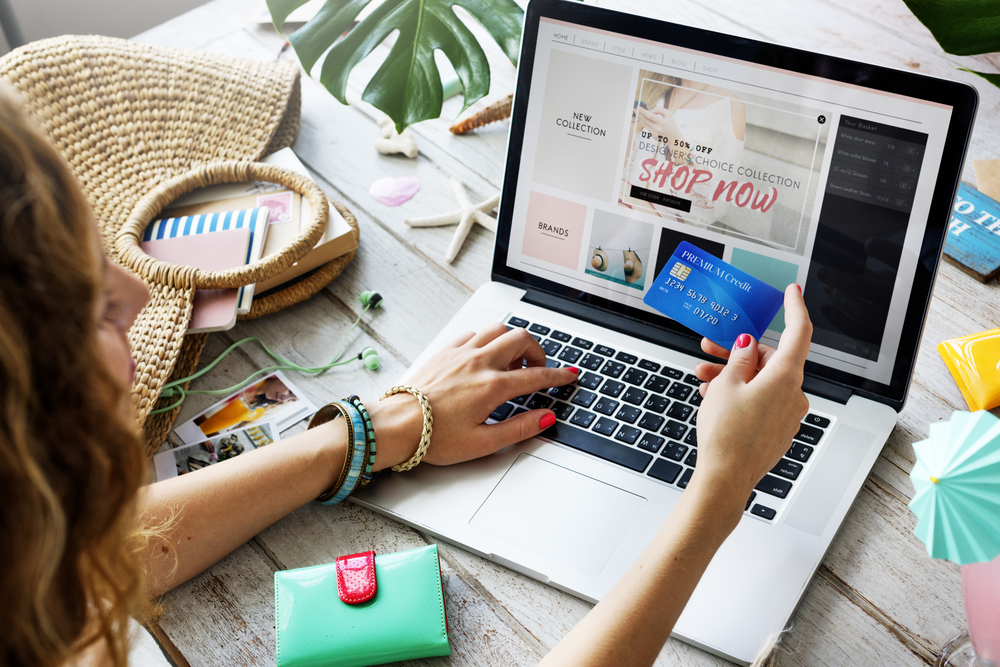 Woman shopping online with a laptop and a credit card