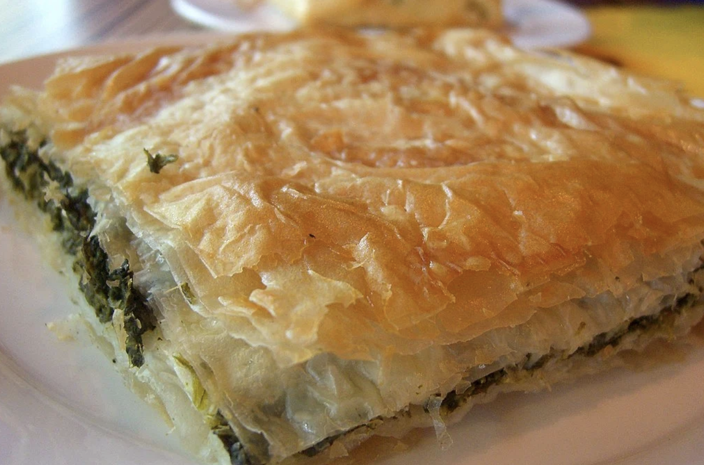 Slice of Greek spanakopita, a spinach pie