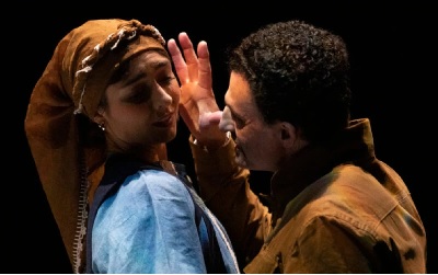 Two actors in a dramatic scene on stage
