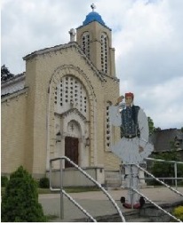 Greek Orthodox church with a statue of an evzone out front